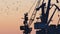 Silhouetted harbor cranes loading freight during golden hour
