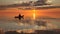 Silhouetted kayaker paddling at sunset on the sea recreational water sports adventure