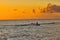 Silhouetted lone surfer in Lahaina harbor on Maui.