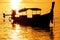 Silhouetted longtail boat at sunrise on Ao Ton Sai, Phi Phi Don