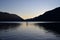 Silhouetted male paddleboarder on Lake Crescent in Olympic National Park.