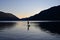 Silhouetted male paddleboarder on Lake Crescent in Olympic National Park.