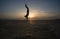 Silhouetted man doing handstand in sunset