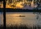 Silhouetted man rows through pond in Payne`s Prairie.CR2