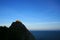 Silhouetted mountains in the sea against the sunset sky