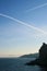 Silhouetted mountains in the sea against the sunset sky