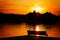 Silhouetted Park Bench By the Lake at Sunset