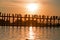 Silhouetted people on U Bein Bridge at sunset, Amarapura, Mandalay Myanmar