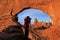 Silhouetted person photographing North Window and Turret Arch, A