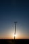 Silhouetted Power Pole On Canadian Prairie At Sunrise Vertical C
