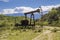 Silhouetted pumpjack in the oil field