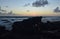 Silhouetted Rock Formations at Dawn on the Beach