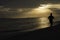 Silhouetted runner on tropical beach