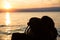 Silhouetted Scuba Diving Tank and Fins and Summer Hat at Sunset