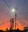 Silhouetted Sentinels: Electric Poles at Sunset