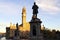 Silhouetted statue against the town hall