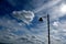 Silhouetted street lighting and cloudy sky.