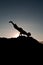 Silhouetted teen exercising