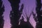 Silhouetted Teepee and trees against purple sky & crescent moon