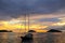 Silhouetted tourist sailboat at sunrise anchored near Chinese Ha