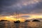 Silhouetted tourist sailboat at sunrise anchored near Chinese Ha