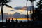 Silhouetted Tourists Watch Sunset over Island Beach