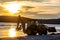 Silhouetted wheel loader Excavator unloading sand