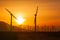 Silhouetted Wind Turbines Over Dramatic Sunset Sky