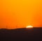 Silhouetted Wind Turbines at Sunset