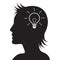 Silhouetted woman head with light bulb inside. Creativity or New ideas concept