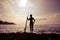 Silhouetted young woman surfer girl with white surfboard