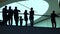 Silhouettes of adults and children standing near glassy handrail in modern building