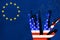 Silhouettes American Weapons  on the background of the EU flag. Stone wall with a map of the European Union. The concept of the