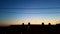 Silhouettes of antennas on the roof at sunset