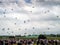 Silhouettes of the army skydiver team against dramatic sky