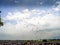 Silhouettes of the army skydiver team against dramatic sky