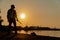 Silhouettes of asian man engineer holding wrenches and standing on shipyard and background is oil storage silo