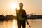 Silhouettes of asian woman engineer holding wrenches and radio communication walkie talkie she standing on shipyard. Background