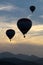 Silhouettes of balloons in the late evening