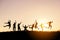 Silhouettes of big group of friends jump and fun