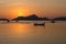 Silhouettes of boats in tropical harbor in the evening. Sunset in lagoon in Philippines, Palawan, El Nido. Sunset on beach.