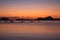 Silhouettes of boats in tropical harbor in the evening. Sunset in lagoon in Philippines, Palawan, El Nido. Sunset on beach.