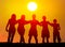 Silhouettes of boys and girls hugging on the beach