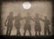 Silhouettes of boys and girls hugging on the beach on sunny summer day