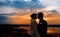 Silhouettes of the bride and groom on the background of the sett