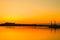 silhouettes of buildings on the river bank at sunset