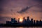 Silhouettes of buildings surrounded by the river under the sunlight during the sunset in Chongqing