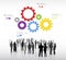 Silhouettes of Business People Discussing and Multicolored Gears