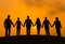 Silhouettes of Business People Holding Hands Outdoors