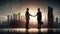 silhouettes of business people shaking hands on abstract skyline background